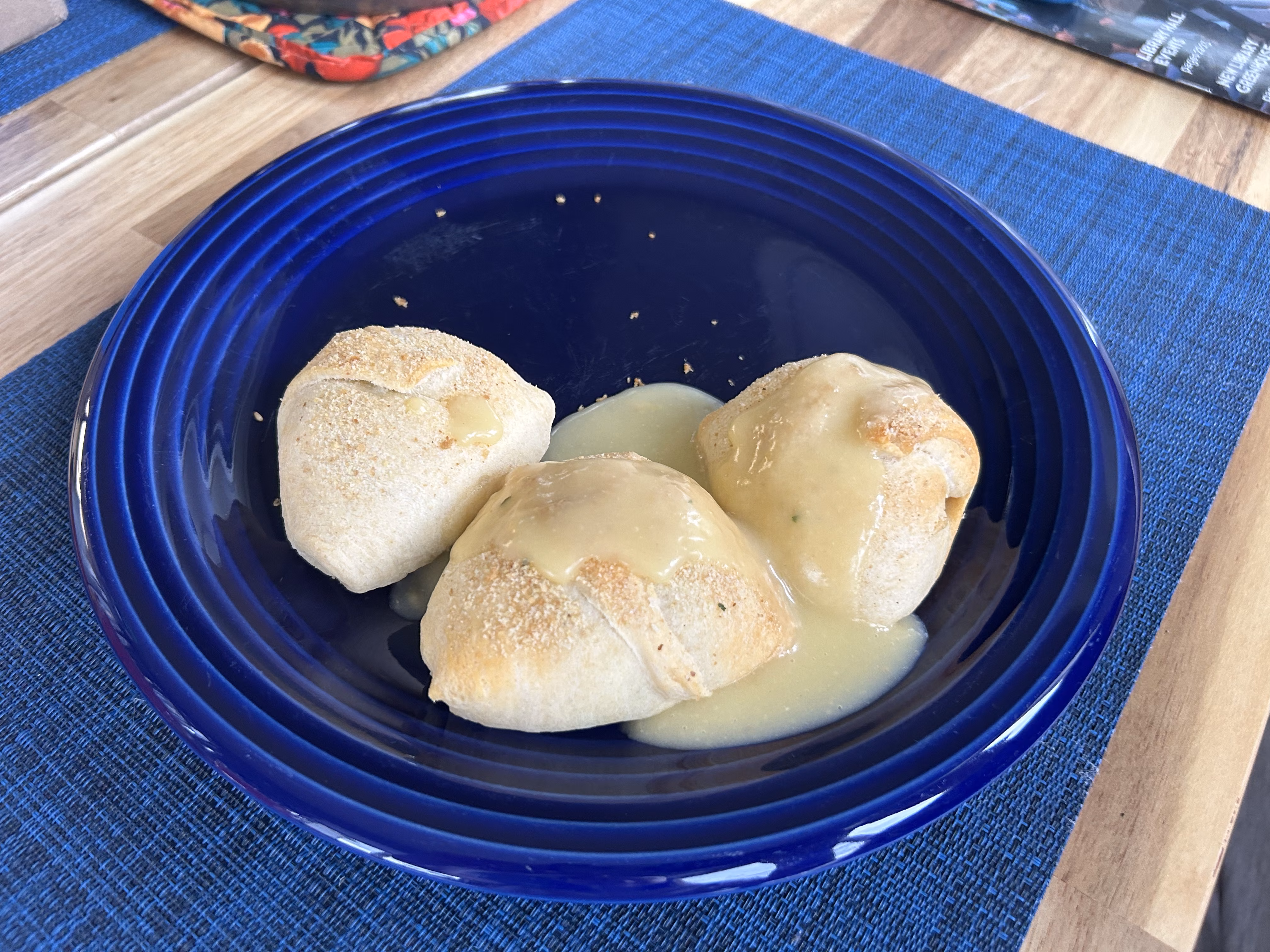 Chicken rolls with gravy on a dinner plate